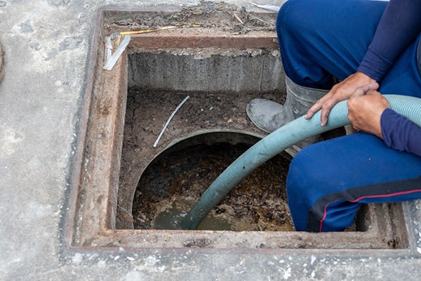 grease trap pumping involves using a vacuum truck to suction out the accumulated grease and waste from the trap
